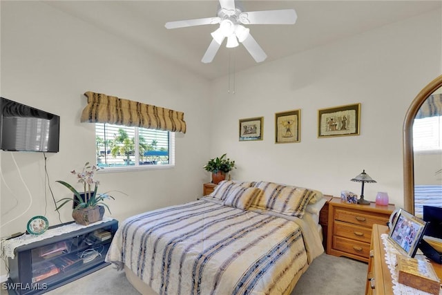 bedroom featuring multiple windows, carpet, and a ceiling fan