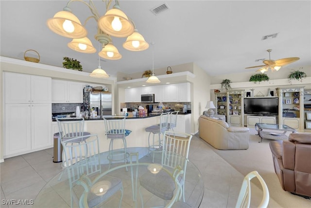 dining space featuring light tile patterned floors, visible vents, and ceiling fan