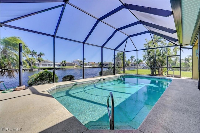 pool featuring glass enclosure, a water view, and a patio area