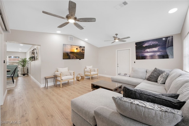 living room featuring light wood-type flooring, visible vents, and lofted ceiling