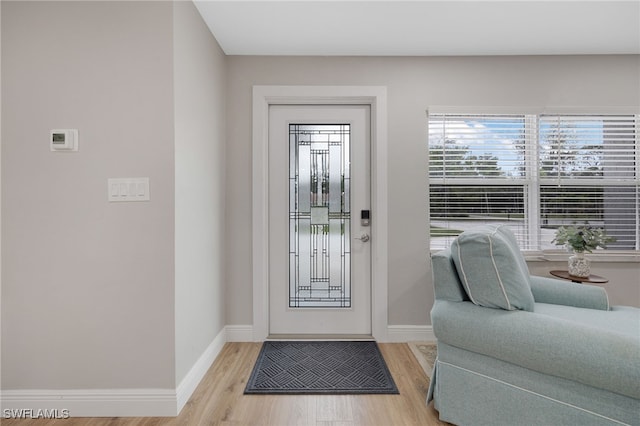 entrance foyer with light wood-type flooring and baseboards