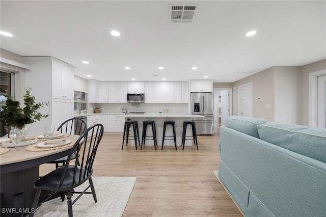 dining room featuring recessed lighting, visible vents, and light wood-style floors