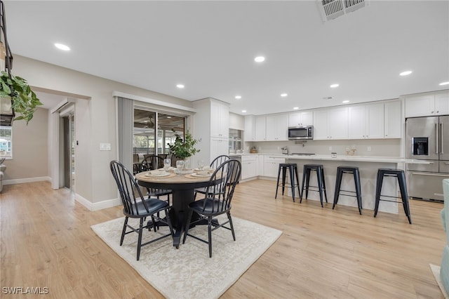 dining room with visible vents, light wood-style flooring, plenty of natural light, recessed lighting, and baseboards