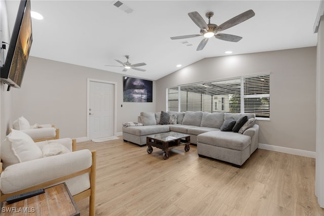 living area with visible vents, baseboards, vaulted ceiling, and light wood finished floors