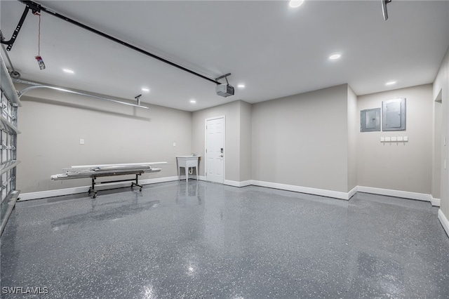 garage featuring electric panel, baseboards, and a garage door opener