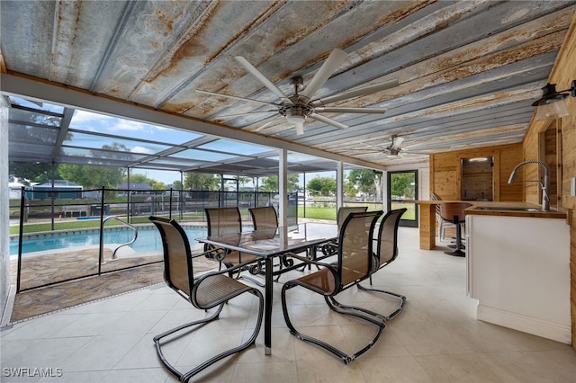 sunroom / solarium featuring a sink, a swimming pool, ceiling fan, and wooden ceiling