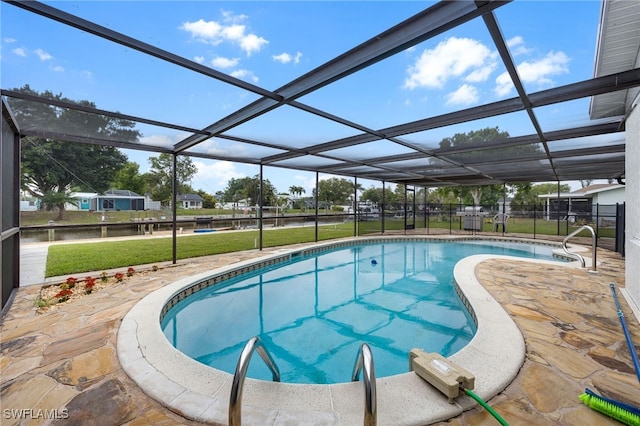 pool featuring a patio, a lawn, and a lanai