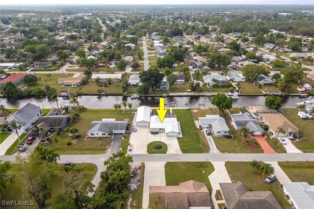 birds eye view of property with a residential view and a water view