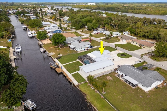 drone / aerial view featuring a residential view and a water view