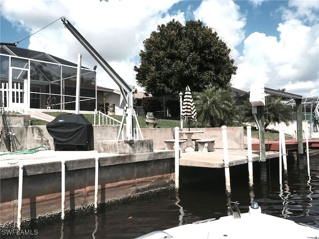 dock area featuring a lanai and a water view