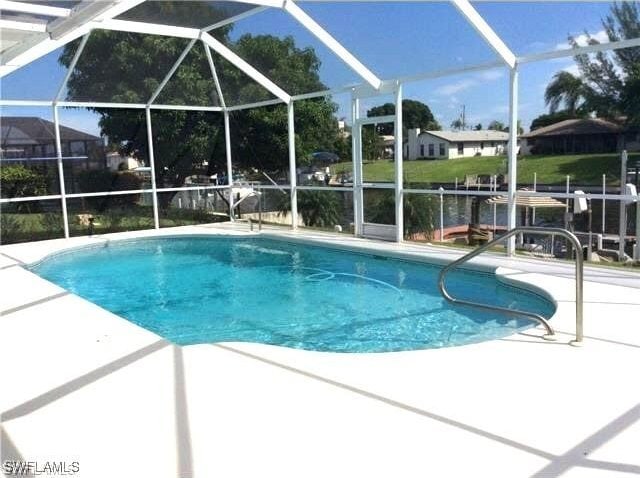 outdoor pool featuring a patio area and a lanai