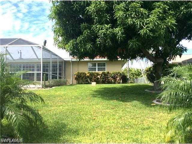 view of yard with glass enclosure