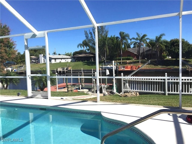 pool featuring glass enclosure and a patio