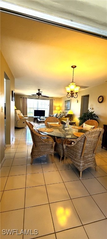 dining room with light tile patterned floors and a notable chandelier