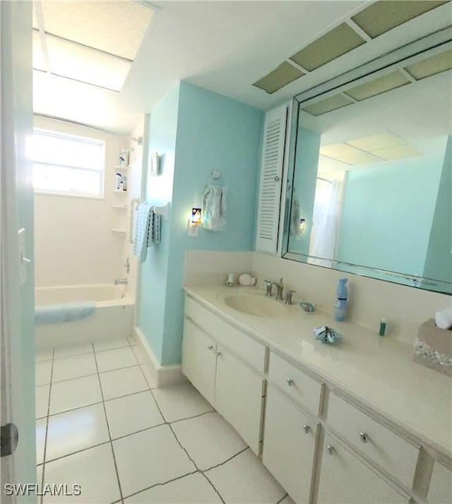 bathroom with tile patterned flooring, vanity, and shower / bath combo with shower curtain