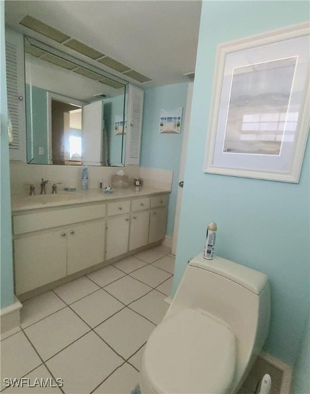 bathroom featuring tile patterned floors, toilet, and vanity