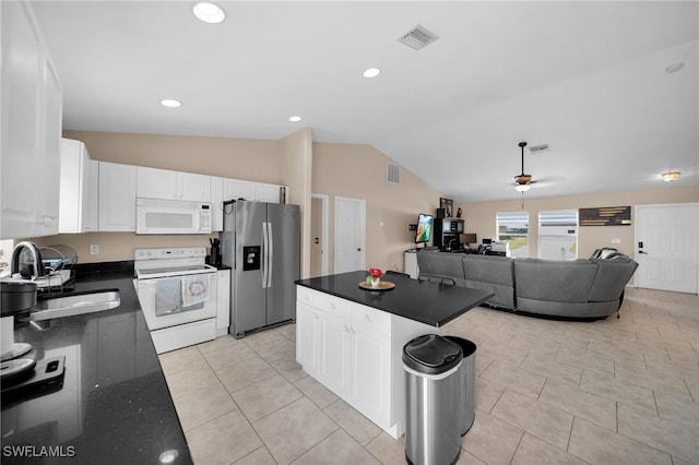 kitchen featuring a sink, visible vents, white appliances, and white cabinets