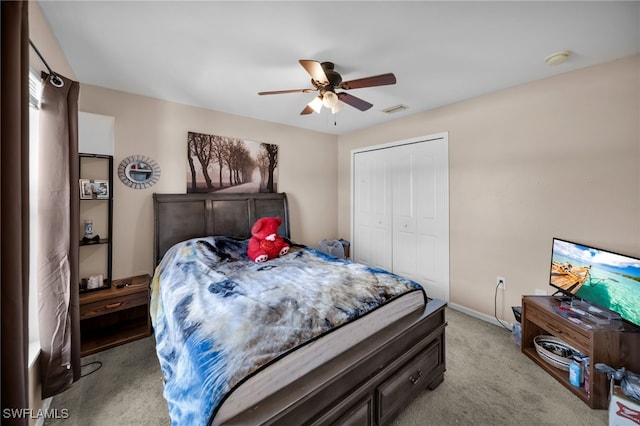 bedroom with visible vents, ceiling fan, baseboards, light carpet, and a closet