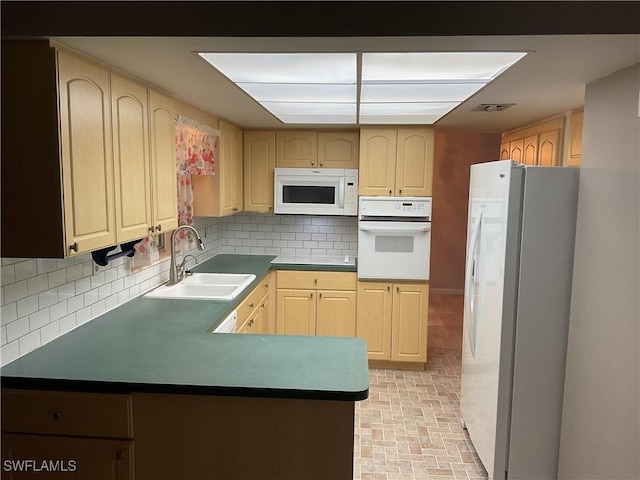 kitchen with visible vents, light brown cabinets, a sink, white appliances, and decorative backsplash