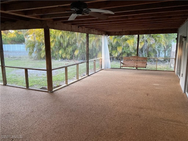 unfurnished sunroom featuring ceiling fan