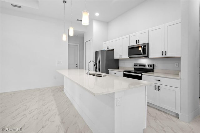 kitchen featuring a sink, white cabinets, marble finish floor, and stainless steel appliances