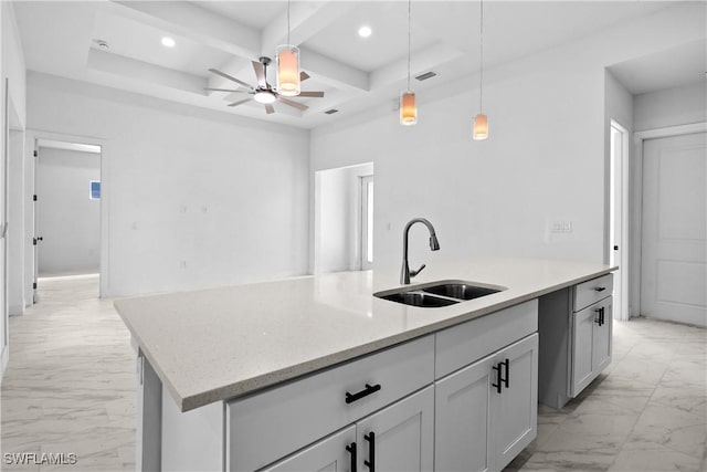 kitchen with marble finish floor, an island with sink, a sink, coffered ceiling, and recessed lighting