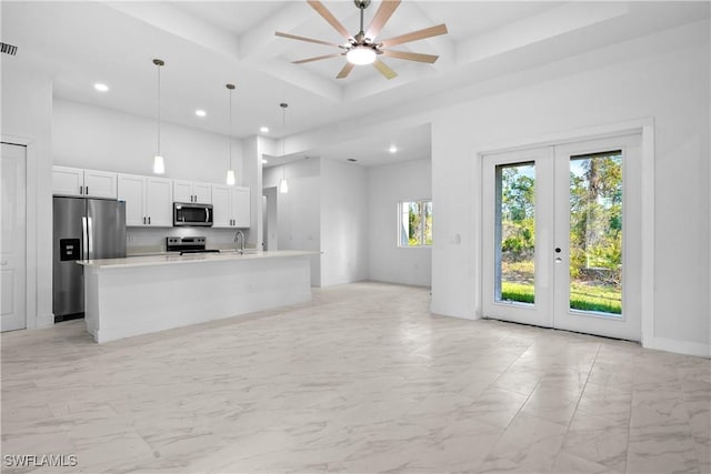 kitchen with coffered ceiling, a high ceiling, stainless steel appliances, french doors, and marble finish floor