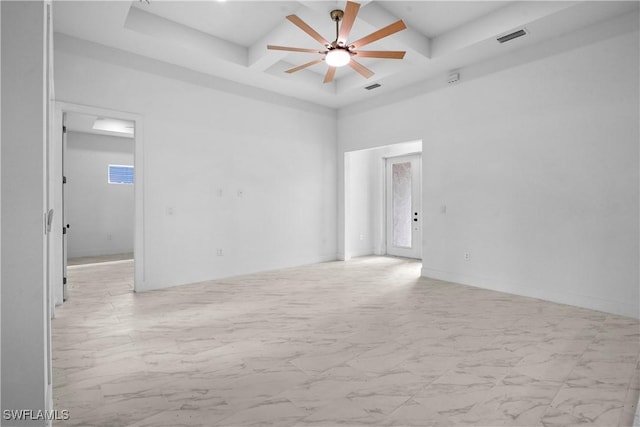 spare room featuring a ceiling fan, visible vents, coffered ceiling, a towering ceiling, and marble finish floor