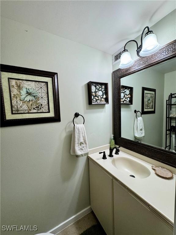 bathroom with vanity and baseboards