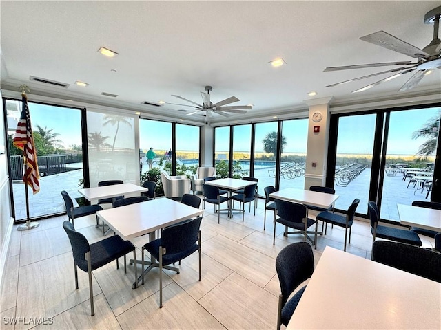 dining space with a wall of windows, plenty of natural light, and visible vents