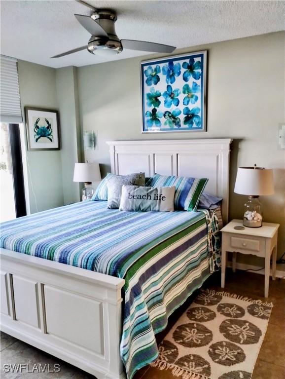 bedroom with a textured ceiling and ceiling fan