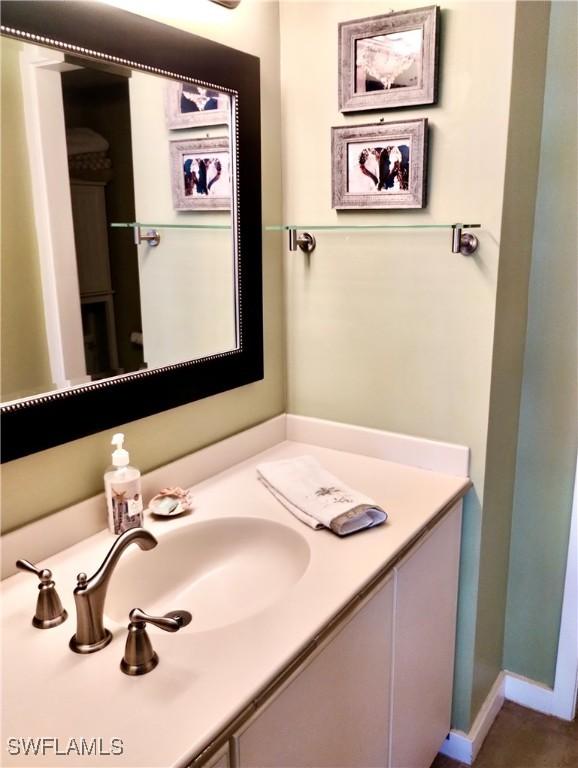 bathroom with baseboards and vanity