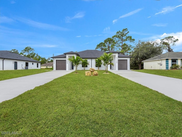 ranch-style home with a garage, a front yard, and driveway