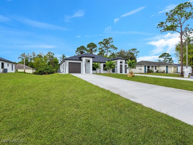 view of front of house with driveway, an attached garage, a front lawn, and a shingled roof