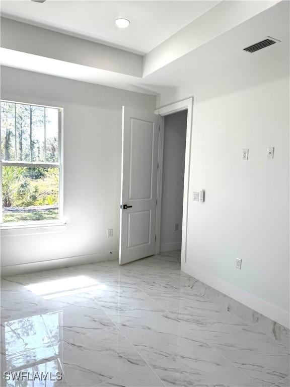 empty room with recessed lighting, baseboards, visible vents, and marble finish floor