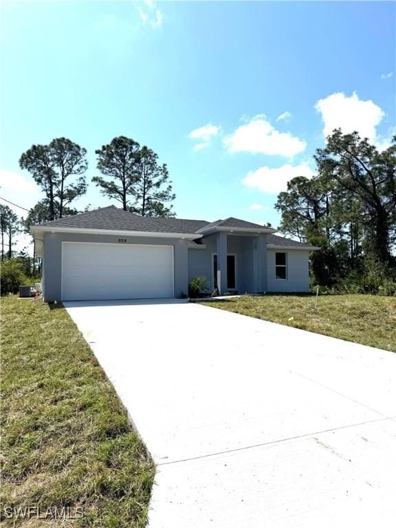 single story home with a front yard, a garage, driveway, and stucco siding