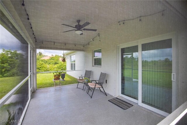 exterior space featuring ceiling fan