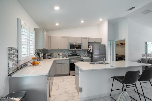 kitchen featuring visible vents, gray cabinets, a sink, appliances with stainless steel finishes, and marble finish floor