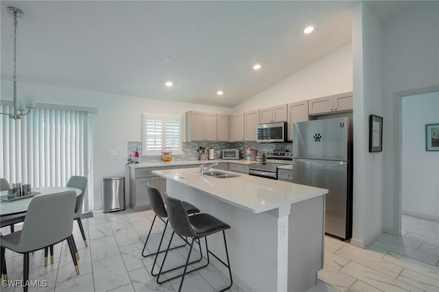 kitchen with marble finish floor, appliances with stainless steel finishes, gray cabinetry, and light countertops