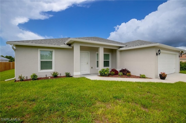 view of front of property with a garage, stucco siding, a front lawn, and fence