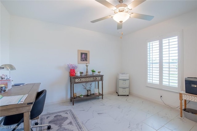 home office featuring marble finish floor and a ceiling fan