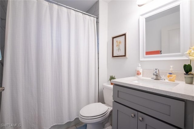 bathroom featuring toilet, vanity, and a shower with curtain