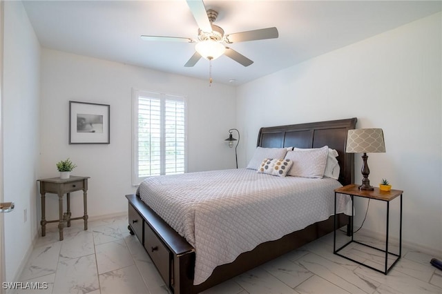 bedroom featuring baseboards, marble finish floor, and a ceiling fan