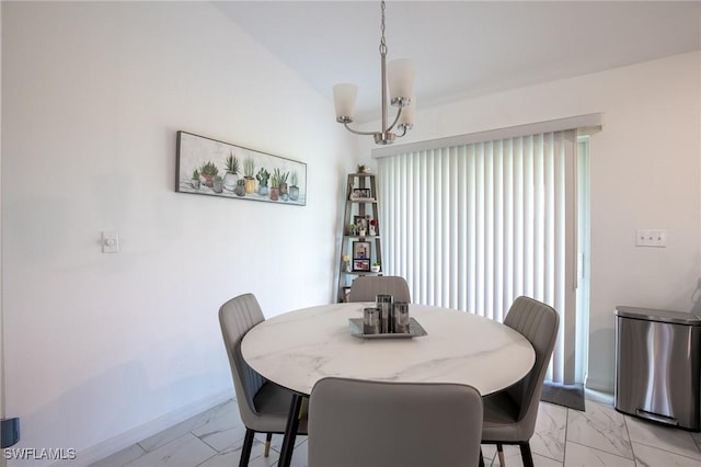 dining space featuring baseboards, a notable chandelier, and marble finish floor