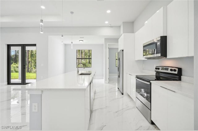 kitchen with stainless steel appliances, marble finish floor, modern cabinets, and white cabinetry