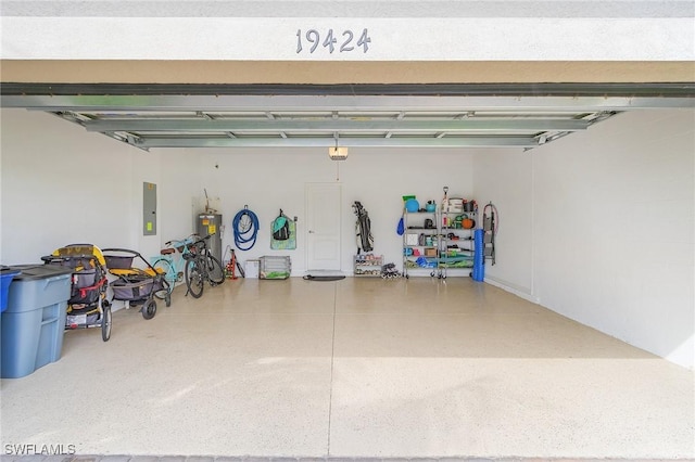 garage with electric panel, electric water heater, and a garage door opener