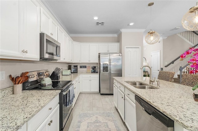 kitchen featuring visible vents, ornamental molding, a sink, white cabinets, and appliances with stainless steel finishes