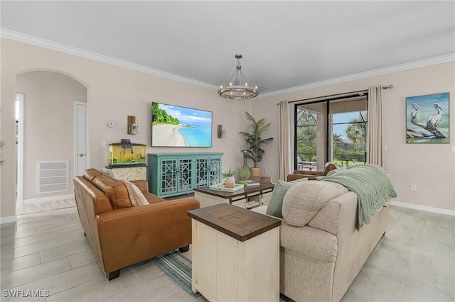 living room featuring visible vents, arched walkways, a notable chandelier, and ornamental molding