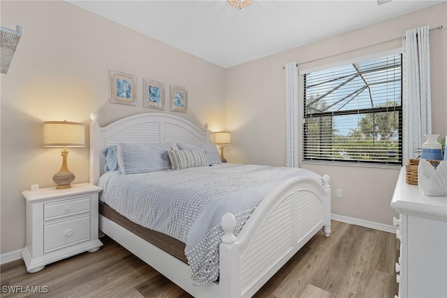 bedroom with baseboards and light wood-style flooring