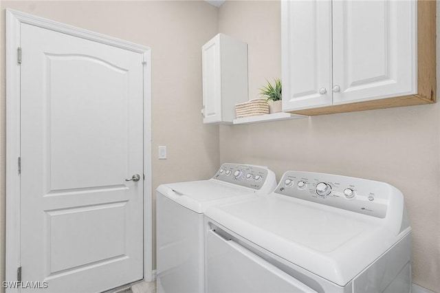 washroom featuring cabinet space and washing machine and dryer